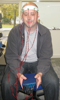 Paul Marshall testing a prototype vibrotactile belt on his head (October 2008). Photo by Jon Bird.